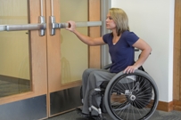 Girl in wheelchair at door